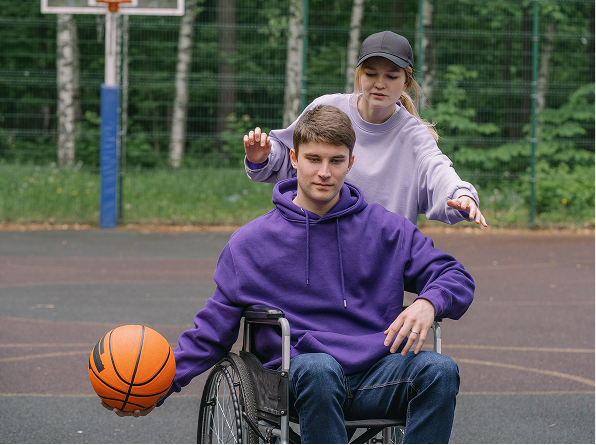 Person in wheelchair dribbling a basketball
