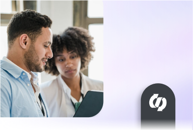 Two coworkers having a conversation while reviewing something on a tablet