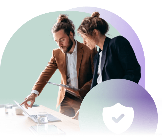 Two business professionals reviewing a laptop screen together, with a large shield icon overlay symbolizing trust and security in digital accessibility.